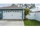 White two-car garage with decorative windows and black accents at 5424 81St Avenue E Cir, Palmetto, FL 34221