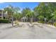 Exterior view of the entrance to the community featuring mature landscaping and attractive building exteriors at 5711 Soldier Cir # 204, Sarasota, FL 34233