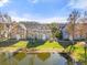 Beautiful multi-story townhome with well-manicured lawn and lovely pond view on a sunny day at 5711 Soldier Cir # 204, Sarasota, FL 34233