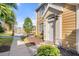 Inviting front entrance of a two-story home, surrounded by lush landscaping and serene lake view at 5711 Soldier Cir # 204, Sarasota, FL 34233