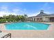 A sparkling blue community pool near a clubhouse with covered verandas and comfortable seating at 5711 Soldier Cir # 204, Sarasota, FL 34233