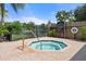 Community spa with a brick patio, safety rail, and spa rules posted near the gate. A life preserver hangs on the fence at 5711 Soldier Cir # 204, Sarasota, FL 34233