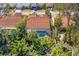 Aerial view of a home with a screened pool surrounded by lush greenery, showcasing privacy at 5827 Beaurivage Ave, Sarasota, FL 34243