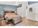 Spacious main bedroom with a high ceiling, wood floors, a platform bed, and modern decor at 5827 Beaurivage Ave, Sarasota, FL 34243