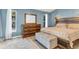 Main bedroom featuring hardwood floors, a platform bed, a wood dresser, and blue painted walls at 5827 Beaurivage Ave, Sarasota, FL 34243