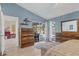 Bright main bedroom with access to the pool area, showcasing wood floors and blue painted walls at 5827 Beaurivage Ave, Sarasota, FL 34243