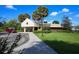 Exterior shot of the Longwood Park community center with covered entrance, lush landscaping, and ample parking at 5827 Beaurivage Ave, Sarasota, FL 34243