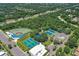 Aerial shot showcases baseball and tennis courts, nestled within a lush, green community at 5827 Beaurivage Ave, Sarasota, FL 34243