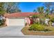 Inviting single-story home featuring a two car garage and well-manicured landscaping at 5827 Beaurivage Ave, Sarasota, FL 34243