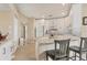 Bright kitchen featuring white cabinets, granite countertops, a breakfast bar, and stainless steel appliances at 5827 Beaurivage Ave, Sarasota, FL 34243