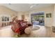 Bright living room with views of the pool area and wood flooring at 5827 Beaurivage Ave, Sarasota, FL 34243