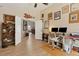 Bright home office with an open doorway, multiple monitors, and a sleek adjustable-height desk at 5827 Beaurivage Ave, Sarasota, FL 34243