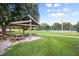 Relaxing shaded picnic tables are near the tennis courts at Longwood Park, creating a space for relaxation and fun at 5827 Beaurivage Ave, Sarasota, FL 34243