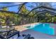 Beautiful screened-in pool surrounded by lush landscaping, creating a private backyard oasis at 5827 Beaurivage Ave, Sarasota, FL 34243