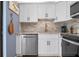 Modern kitchen with white shaker cabinets, stainless steel appliances, and granite countertops at 6084 Red Maple Rd, Bradenton, FL 34210