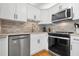 Updated kitchen featuring stainless steel appliances and stylish tile backsplash at 6084 Red Maple Rd, Bradenton, FL 34210