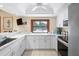 Modern kitchen with white cabinets and a view of the pool at 6084 Red Maple Rd, Bradenton, FL 34210