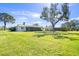 Large backyard with grassy area and partial view of house at 617 Whitfield Ave, Sarasota, FL 34243