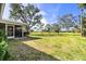 Screened porch overlooking a grassy backyard and golf course at 617 Whitfield Ave, Sarasota, FL 34243