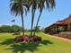 Landscaped grounds near clubhouse with palm trees at 617 Whitfield Ave, Sarasota, FL 34243