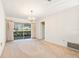 Dining room with chandelier, sliding doors to patio, and view of kitchen at 617 Whitfield Ave, Sarasota, FL 34243