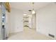 View of a retro dining room with kitchen access and sliding glass doors at 617 Whitfield Ave, Sarasota, FL 34243