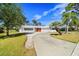 Ranch home with circular driveway and palm trees at 617 Whitfield Ave, Sarasota, FL 34243