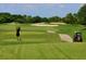 Person golfing on a lush green golf course at 617 Whitfield Ave, Sarasota, FL 34243