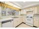 Bright kitchen with white appliances and light-colored cabinets at 617 Whitfield Ave, Sarasota, FL 34243