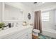 Bathroom with white vanity, bathtub, and neutral tile at 6228 Fordham Pl, Bradenton, FL 34207