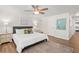 King-size bed, wood floors, and ceiling fan in this bright bedroom at 6228 Fordham Pl, Bradenton, FL 34207