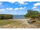 Scenic waterfront park with a bench overlooking the water at 6228 Fordham Pl, Bradenton, FL 34207