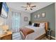 Bright bedroom featuring a wooden bed frame, and neutral-toned decor at 6428 Devesta Loop, Palmetto, FL 34221