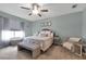 Bright bedroom with plush bed, large window and seating area at 6428 Devesta Loop, Palmetto, FL 34221