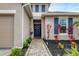 Front entry with walkway, blue door, and landscaping at 6428 Devesta Loop, Palmetto, FL 34221