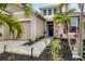 Front entry with walkway, landscaping, and blue door at 6428 Devesta Loop, Palmetto, FL 34221