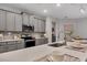 Modern kitchen featuring gray cabinets and stainless steel appliances at 6428 Devesta Loop, Palmetto, FL 34221