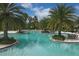 Stunning resort-style pool surrounded by palm trees at 6428 Devesta Loop, Palmetto, FL 34221