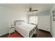 Cozy bedroom with a white bed, dresser, and ceiling fan at 6589 Fairway Gardens Dr, Bradenton, FL 34203