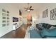 Open concept living area with dark hardwood floors, sectional sofa and a view into the kitchen at 6589 Fairway Gardens Dr, Bradenton, FL 34203