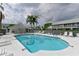 Community pool with lounge chairs and a covered patio at 6589 Fairway Gardens Dr, Bradenton, FL 34203