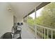 Relaxing screened balcony with wicker chairs and wooded views at 6589 Fairway Gardens Dr, Bradenton, FL 34203