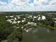 Aerial view of a community with lake and houses at 6669 Windjammer Pl, Lakewood Ranch, FL 34202