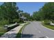 Landscaped entrance to a community with a guard house and flag at 6669 Windjammer Pl, Lakewood Ranch, FL 34202