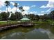 Community gazebo with wooden dock and lake access at 6669 Windjammer Pl, Lakewood Ranch, FL 34202