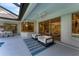 Relaxing covered patio with seating area, adjacent to pool and house at 6669 Windjammer Pl, Lakewood Ranch, FL 34202