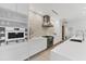 Modern white kitchen with a long island and unique backsplash at 6669 Windjammer Pl, Lakewood Ranch, FL 34202