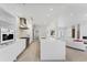 Modern white kitchen with stainless steel appliances and ample cabinetry at 6669 Windjammer Pl, Lakewood Ranch, FL 34202