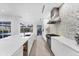 Bright white kitchen features modern cabinetry and a unique backsplash at 6669 Windjammer Pl, Lakewood Ranch, FL 34202