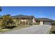 Front view of the house with a paved driveway and mature landscaping at 7020 Sena Rd, North Port, FL 34291